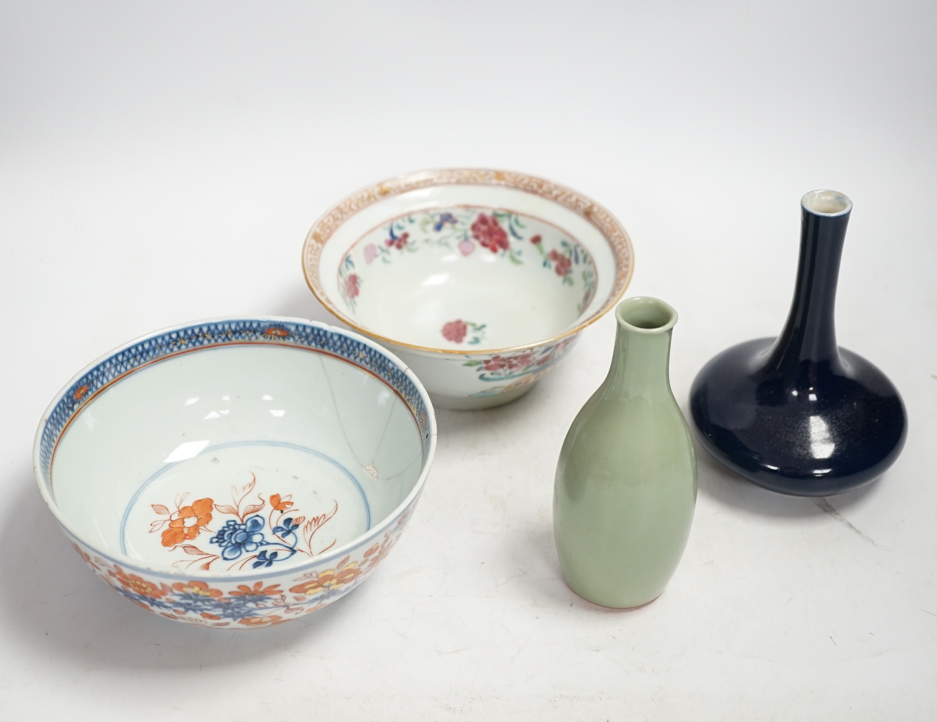 A Chinese famille rose bowl, an Imari patterned bowl, a small blue glazed vase and a similar celadon glazed vase, 18th century and later. Condition - both bowls badly cracked, overall poor